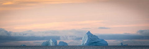 Icebergs drifting across Scoresby Sound at sunset, Greenland, fine art landscape photograph by Peter Cox