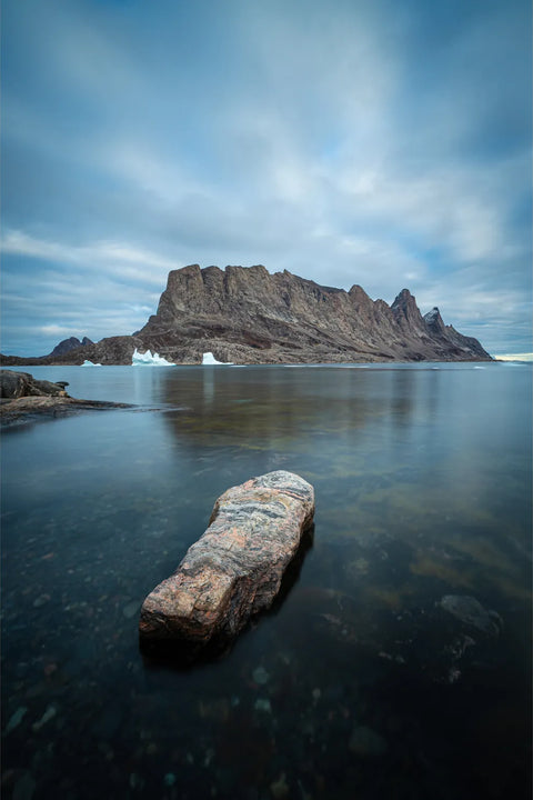 Still Arctic waters and towering cliffs with iceberg in Scoresby Sound, Greenland — fine art landscape photograph by Peter Cox