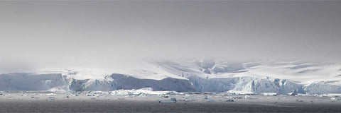Panoramic view of a vast glacier front and snow-covered mountains under overcast skies at Charlotte Bay, Antarctic Peninsula, fine art landscape photograph by Peter Cox