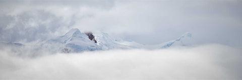 Snow-covered peaks emerging from cloud over a glacier at Charlotte Bay, Antarctic Peninsula, fine art landscape photograph by Peter Cox