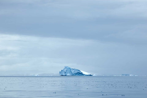 A solitary iceberg floating in calm Antarctic waters near Cuverville Island — fine art landscape photograph by Peter Cox