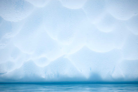 Sculpted iceberg with scalloped textures near Cuverville Island, Antarctic Peninsula — fine art landscape photograph by Peter Cox