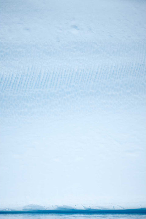 Close-up of ridged iceberg textures in pale blue and white near Cuverville Island, Antarctic Peninsula — fine art landscape photograph by Peter Cox