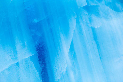 Abstract close-up of blue ice textures and layers on an iceberg in Svalbard — fine art landscape photograph by Peter Cox