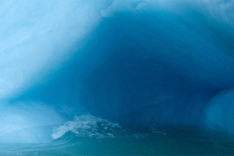 Close-up of blue ice textures and cavern details on an iceberg in Svalbard — fine art landscape photograph by Peter Cox