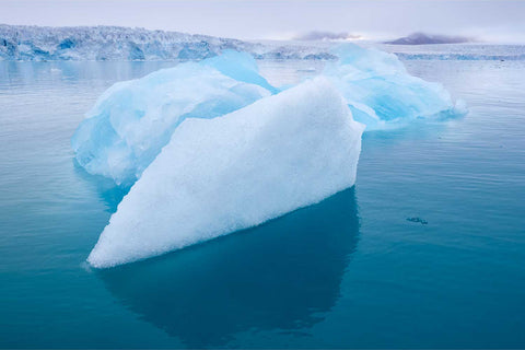 Vivid blue iceberg drifting in misty waters before a glacier, Svalbard — fine art landscape photograph by Peter Cox