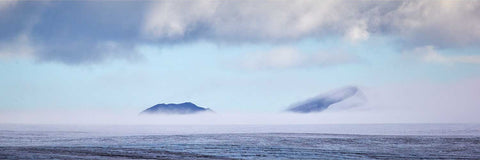 Panoramic view of mountains emerging from mist over a glacier at Isbukta, Svalbard, fine art landscape photograph by Peter Cox
