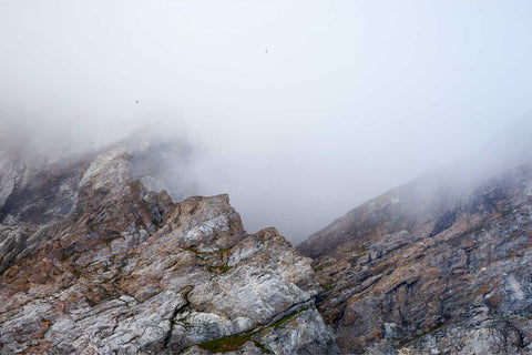 Rugged cliffs of Gnalodden emerging from thick mist, Svalbard — fine art landscape photograph by Peter Cox