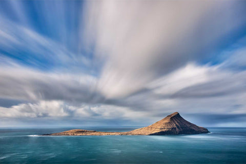 Long exposure of the remote island of Koltur under streaking clouds, Faroe Islands