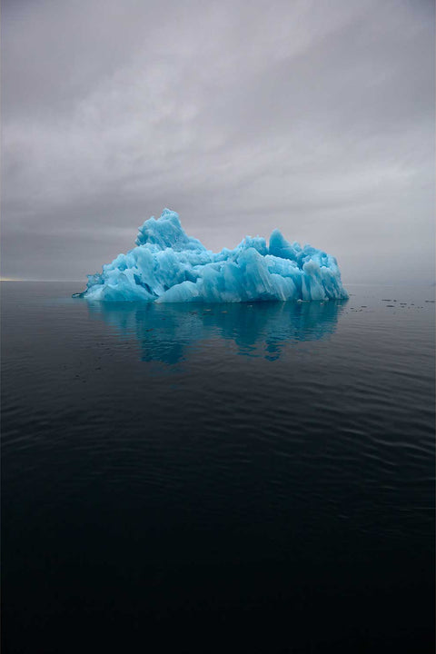 Deep blue iceberg in fog along the Greenland coast — fine art landscape photograph by Peter Cox