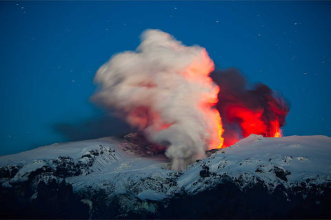 Eyjafjallajokull volcano eruption with lava glow against snowy mountains, Iceland, fine art landscape photograph by Peter Cox