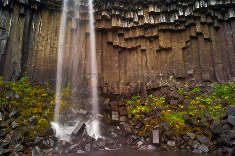 Svartifoss waterfall cascading over dark hexagonal basalt columns in Vatnajokull National Park, Iceland