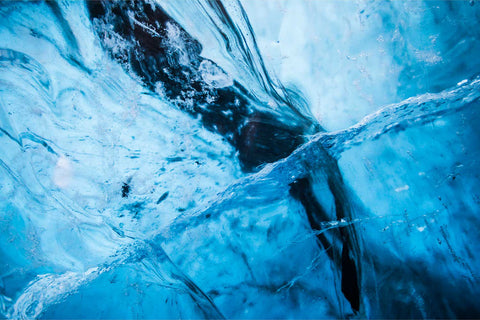 Abstract swirls and patterns of deep blue ice inside a glacier cave at Breidamerkursjokull, Iceland