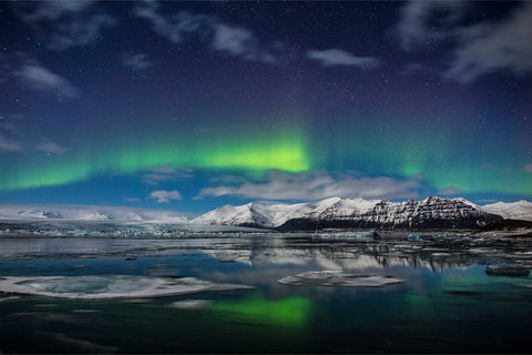 Aurora over Jokulsarlon Glacier Lagoon with snow-capped mountains, Iceland — fine art landscape photograph by Peter Cox