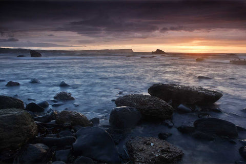 Sunset over Bengore Head with waves rolling over rocks, Co. Antrim, Ireland — fine art landscape photograph by Peter Cox