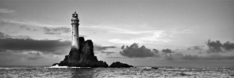 The Fastnet Lighthouse standing proud on a calm summer evening off West Cork in black and white panoramic view