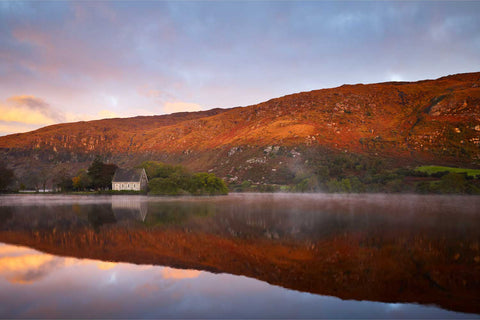 Sunrise over Gougane Barra lake with mountains reflected in still water, County Cork, Ireland — fine art landscape photograph by Peter Cox