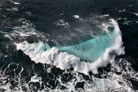 Massive wave crashing against the Fastnet Rock lighthouse off the Cork coast