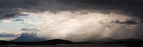 Evening sunburst settling over the Beara Peninsula mountains with Bantry Bay in the foreground, Cork