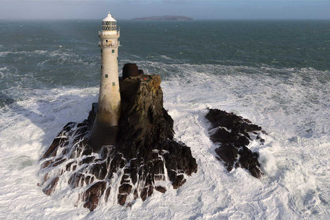 Aerial view of the Fastnet Lighthouse on its rocky island surrounded by churning Atlantic seas off West Cork