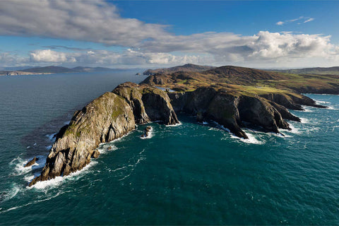 Aerial view of Three Castle Head on the Mizen Peninsula with rugged cliffs, castle ruins and the Atlantic Ocean