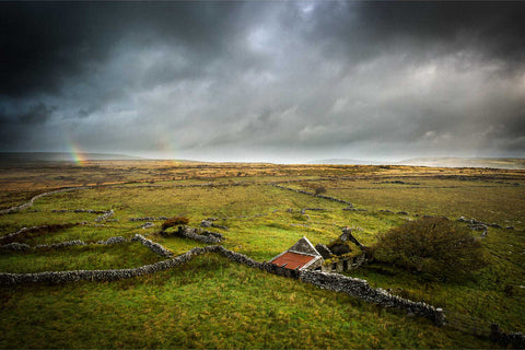 Ruined cottage with rainbow over the Burren limestone landscape, Co. Clare, Ireland, fine art aerial photograph by Peter Cox