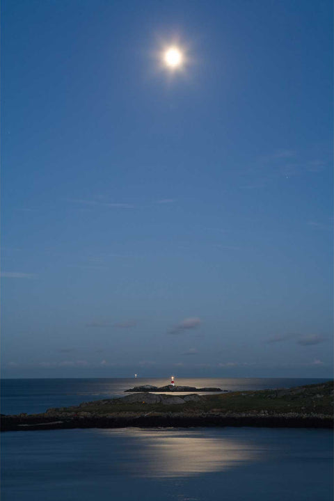Moonlight reflecting on the sea near the Muglins lighthouse off Dalkey Island, Dublin, with the Kish light on the horizon