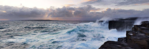 Dramatic storm waves battering tall cliffs at sunset on the west coast of Inis Meain, Aran Islands