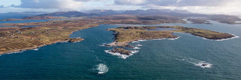 Aerial view of Omey Island off the Connemara coast in Galway with the Twelve Bens mountains in the distance