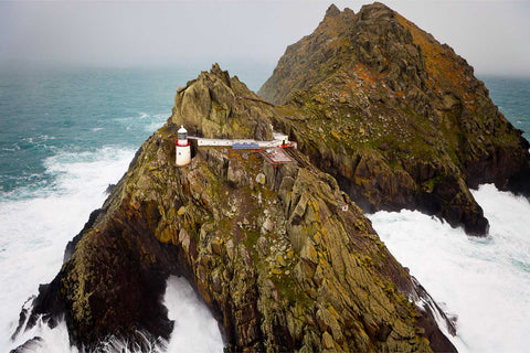 An Tiaracht lighthouse in stormy seas, Blasket Islands, County Kerry, Ireland — aerial fine art photograph by Peter Cox