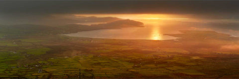 Dawn aerial view of Ventry Harbour from Mount Eagle with boats at anchor and morning mist rising from farmland