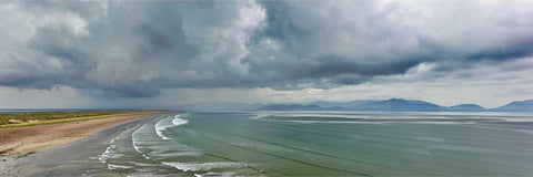 Elevated panoramic view of Inch Beach with curving waves and surfers on Dingle Bay, Co. Kerry — fine art landscape photograph by Peter Cox
