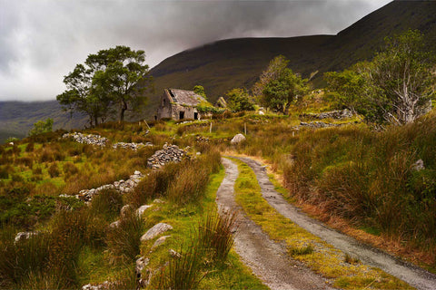 Remote farmhouse in the heart of the Black Valley near Killarney framed by wild Kerry mountains