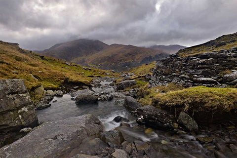 Mountain stream flowing past ruined farm buildings with cloud-kissed Lackabane peak beyond, Caha Mountains, Kerry