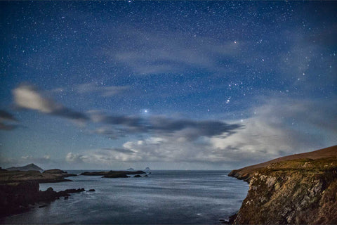 The Skellig Islands under a starry sky with the constellation Orion above Bray Head, Valentia Island, Kerry