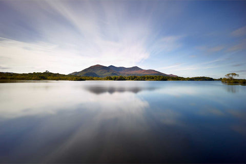 Warm summer light on still Lough Leane looking towards Tomies and Purple Mountain, Killarney, Kerry