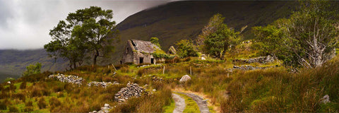 A lone house at the heart of the Black Valley near Killarney surrounded by craggy mountains on all sides