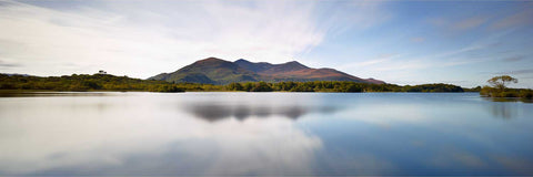 Panoramic view of calm Lough Leane on a summer evening with Purple Mountain reflected in still water, Killarney, Kerry