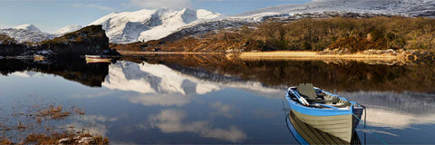 Panoramic winter view over the Upper Lake, Killarney, with snow on the MacGillycuddy's Reeks and moored boats