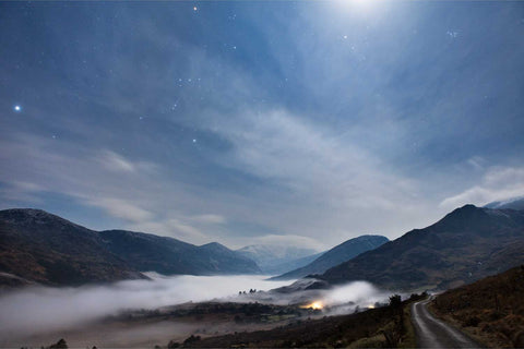 Moonlit ground fog drifting through the Black Valley in Kerry beneath the snow-dusted Macgillycuddy's Reeks with Orion in the starry sky