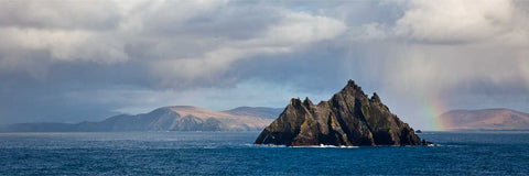 The Small Skellig rising from the Atlantic with a rainbow behind and a rain squall passing, off the Kerry coast