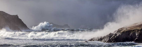 Massive wave breaking at Clogher Head during a winter storm with the Sleeping Giant island on the horizon, Kerry