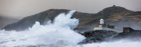 Enormous wave crashing over Cromwell Point Lighthouse on Valentia Island during a winter storm, Kerry