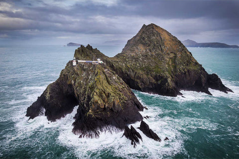 Aerial view of Inis Tiaracht, the westernmost Blasket Island, with lighthouse and dramatic cliffs on a blustery January day, Co. Kerry — fine art aerial photograph by Peter Cox