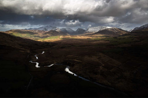 Aerial view of the Owenroe River winding through Glencar valley toward Macgillycuddy's Reeks, Co. Kerry — fine art aerial photograph by Peter Cox