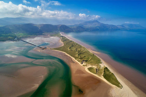 Aerial view of Rossbeigh Beach with sweeping sand curves along the Atlantic and mountains of the Iveragh Peninsula beyond