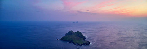 Aerial view of Puffin Island with the Skellig Islands stretching to the horizon at sunset off the Kerry coast