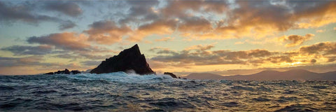 Lemon Rock rising from the Atlantic at sunrise with the Skellig Islands visible beyond, Kerry coast
