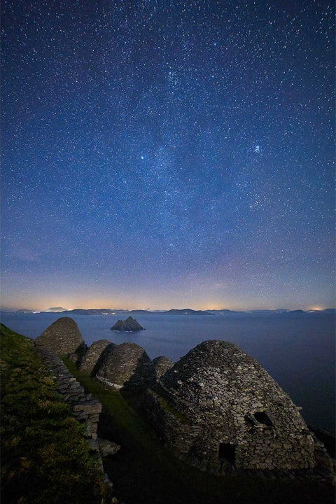 Ancient stone monastery ruins on Skellig Michael under a starry winter sky off the Kerry coast