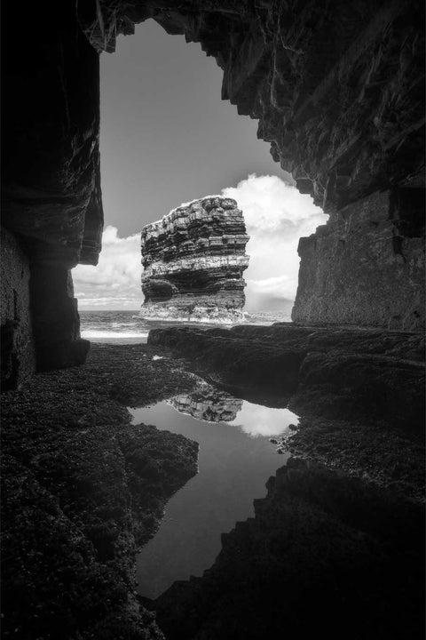Black and white view of Dun Briste sea stack from a sea cave, Co. Mayo, fine art landscape photograph by Peter Cox
